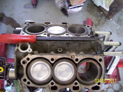 1995 Ford Probe - Close-up of an engine block with pistons visible, resting on a stand.