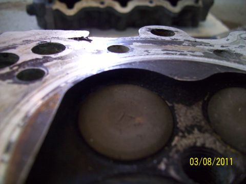 1995 Ford Probe - This image shows a damaged engine cylinder head with valves visible inside the combustion chambers.