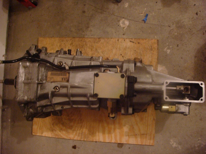 Silver transmission with a label reading 'DXA' and a metal plate attached