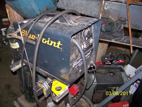 1989 Ford Bronco - A Blue-Point gas wire welder is shown with its associated cables and a welding gas tank nearby.