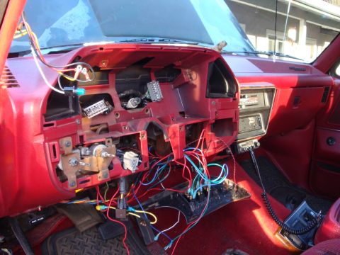 1989 Ford Bronco - The interior of a 1989 Ford Bronco shows a disassembled dashboard with extensive wiring and a CB radio installed.