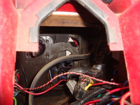 1989 Ford Bronco - Wiring harness and components visible inside a red vehicle's interior.