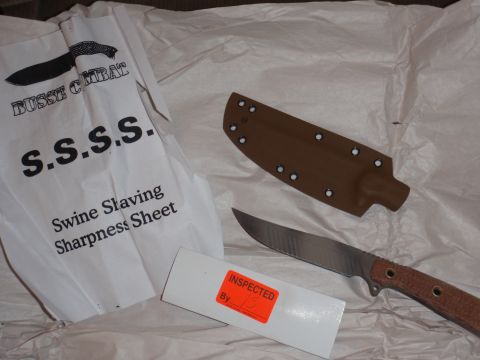 1991 Ford Bronco - A knife, its sheath, and a "Swine Slaving Sharpness Sheet" are laid out on white paper.