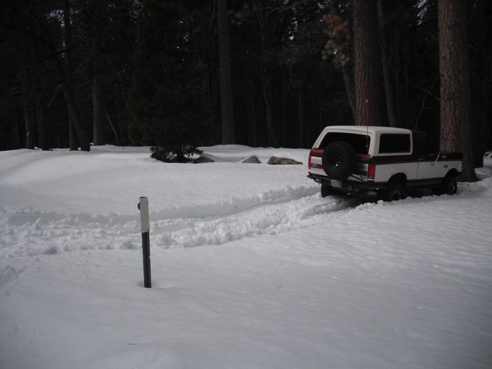 1991 Ford Bronco with spare tire on rear door, driving in snow