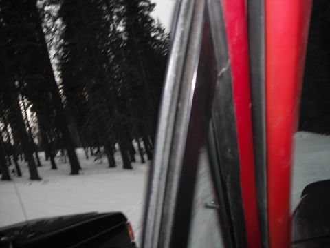 1991 Ford Bronco - Looking out from the interior of a vehicle at a snow-covered forest scene with another vehicle nearby.