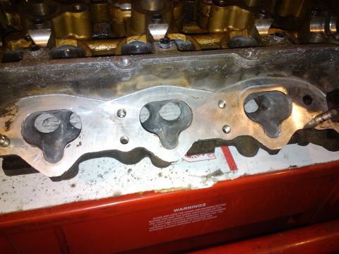 1995 Ford Probe - Close-up of an engine's cylinder head, showing intake ports and internal components.