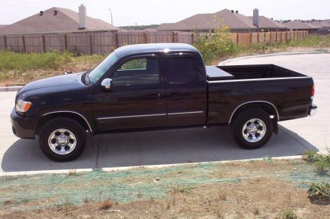 1988 Ford Bronco - This black Toyota Tundra pickup truck is shown from the side. The body style suggests a model year between 2000 and 2006.