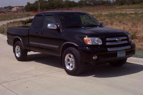 1988 Ford Bronco - This black Toyota Tundra pickup truck is parked on a concrete surface.