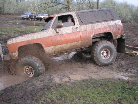 1978 Ford Bronco - Off-road vehicle struggling through deep mud during an outing.