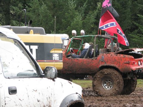 1978 Ford Bronco - Several vehicles are covered in mud, suggesting they have been off-roading in a wet environment.