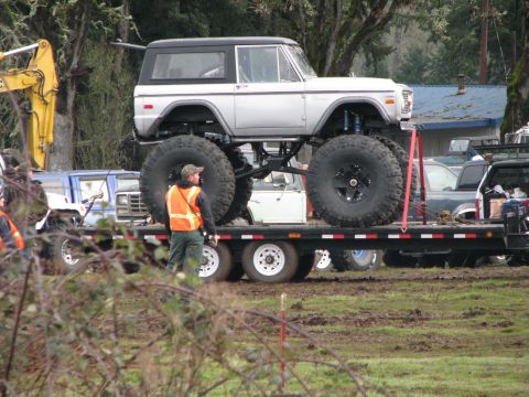 1978 Ford Bronco - Modified 1978 Ford Bronco with oversized tires loaded onto a trailer for transport.