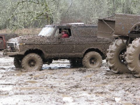 1978 Ford Bronco - 1978 Ford Bronco navigating a challenging muddy terrain.
