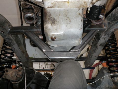 1961 International Scout 800 - Custom bracing is installed under the engine and transmission of this vehicle, showing suspension and drivetrain parts.