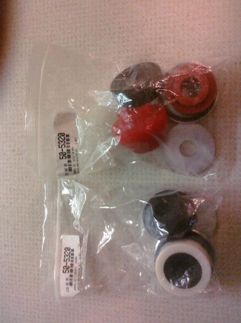 1995 Ford Bronco - Two plastic bags contain various suspension bushings, with one bag clearly labeled with the part number 50-5320.