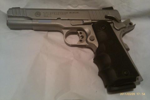 2000 Mercury Grand Marquis - A silver Taurus pistol with a black grip is shown against a white background.