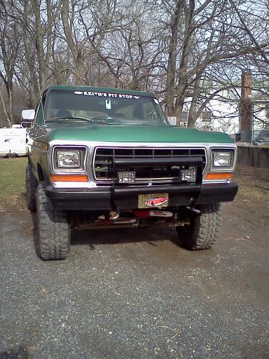 1979 Ford Bronco - This 1979 Ford Bronco is parked outside on a gravel driveway with trees in the background.