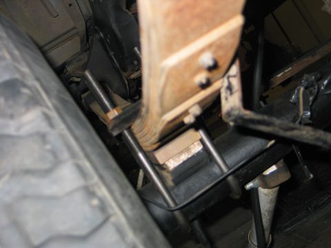 1984 Ford Bronco - Close-up of a vehicle's leaf spring and U-bolt assembly, showing mechanical components.