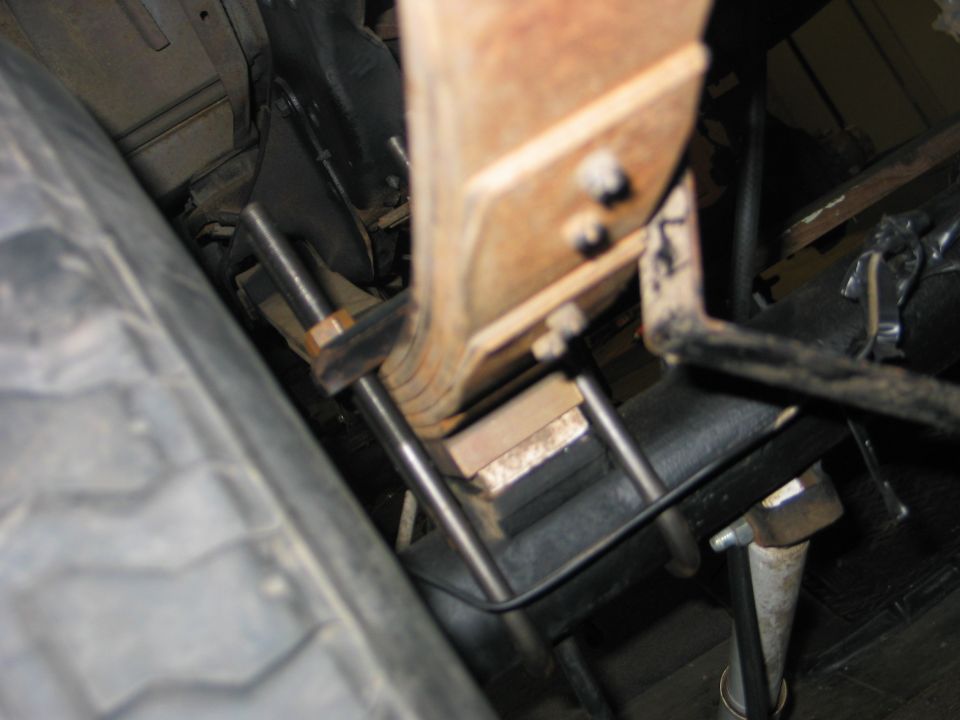 Leaf spring assembly with U-bolts and hardware, close-up view