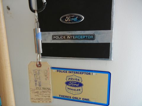 1999 Lincoln Town Car - Ford Police Interceptor badge and license plate with a keychain holding tags.