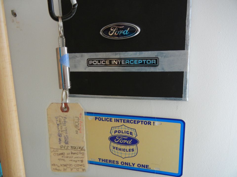Ford Police Interceptor badge and license plate with a keychain attached