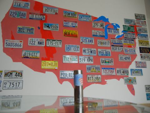 1999 Lincoln Town Car - A wall display features numerous license plates arranged on a map of the United States.
