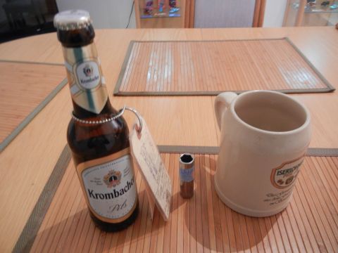 1999 Lincoln Town Car - A Krombacher Pils bottle, a ceramic mug, and a socket wrench bit are arranged on a wooden table.