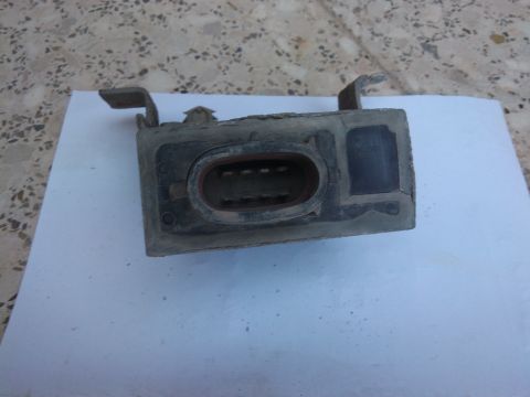 1998 Ford Crown Victoria - This is a close-up view of a dirty electrical connector housing, likely from a vehicle's wiring harness.