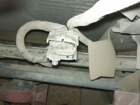 1998 Ford Crown Victoria - Close-up of a vehicle's electrical connector and wiring harness, covered in dust.