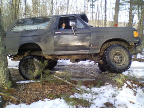 1989 Ford Bronco - This 1989 Ford Bronco navigates a challenging off-road course with snow and rocks.