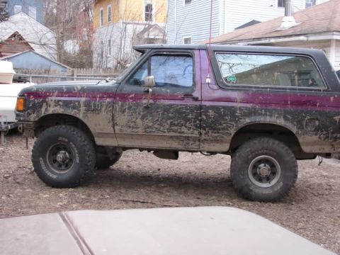 1989 Ford Bronco - This 1989 Ford Bronco is covered in mud, suggesting recent off-road use.