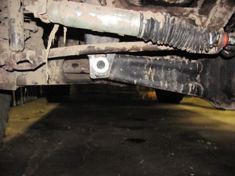 1989 Ford Bronco - Close-up view of vehicle undercarriage components, showing suspension and steering parts.