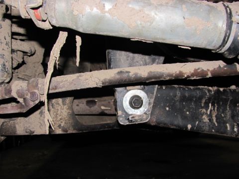 1989 Ford Bronco - Undercarriage view of a vehicle's suspension system, showing a bolted bracket.