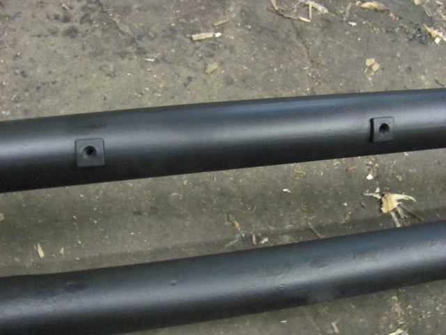 Black metal tubes with square mounting points