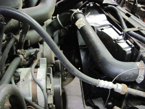 1989 Ford Bronco - Engine bay components including radiator, hoses, and alternator are visible in this close-up view.