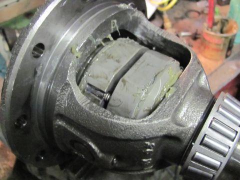 1989 Ford Bronco - A differential assembly, likely for a vehicle, is shown with internal gears coated in grease.