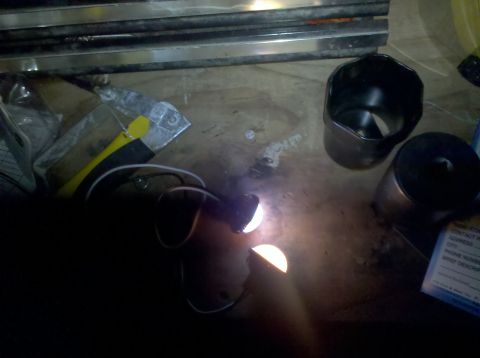 1995 Ford Bronco - A close-up view of welding in progress, with various metal components and tools scattered on a workbench.
