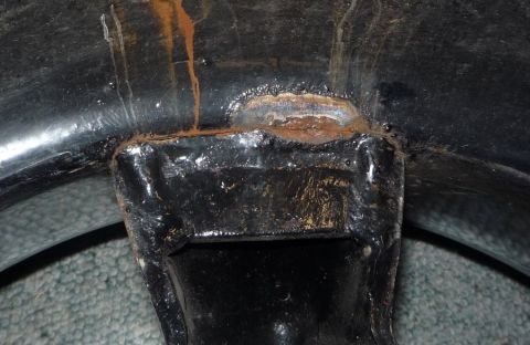 1964 Mercury Monterey - Close-up of a rusty, welded metal bracket, likely from a vehicle's undercarriage.