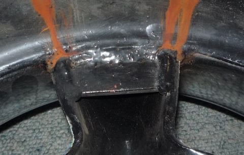 1964 Mercury Monterey - The interior of a wheel well shows rust streaks originating from a seam.