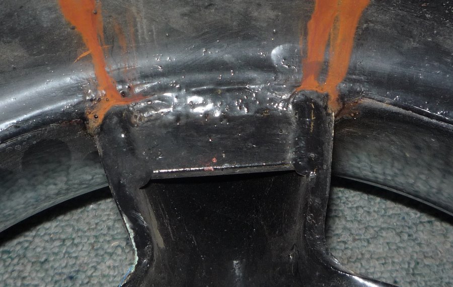 Wheel well interior with rust streaks and Supermotors.net logo