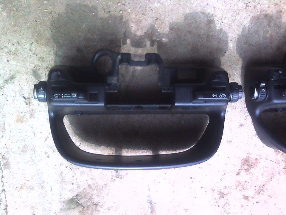 Car dashboard trim piece with light and wiper controls