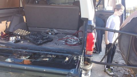 1994 Ford Bronco - Tools and wiring are laid out in the cargo area of a 1994 Ford Bronco.