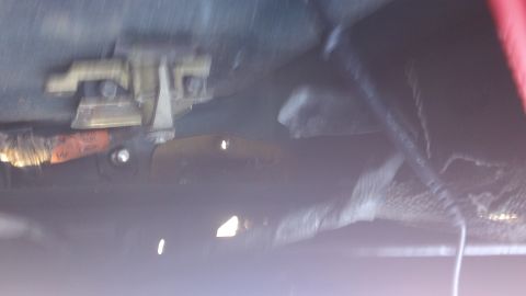 1994 Ford Bronco - Underside view of a vehicle's chassis, showing suspension parts and exhaust system components.