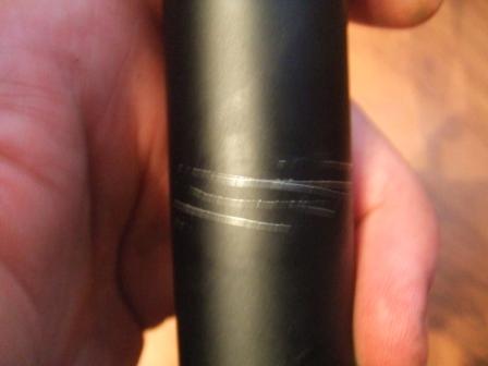 1996 Ford Bronco - A close-up view of a black cylindrical part showing several prominent scratches. The Supermotors.net logo is visible in the lower right cor…