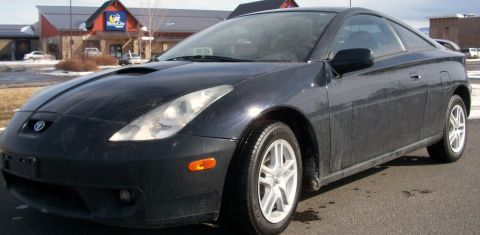 2006 Ford E350 - This black coupe is seen from a 3/4 front angle. The Toyota badge is visible on the front grille.