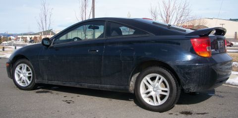 2006 Ford E350 - Side view of a dark blue coupe with a rear spoiler and silver wheels.