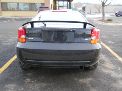 2006 Ford E350 - Rear view of a black Toyota Celica GT with a spoiler and a GT badge.