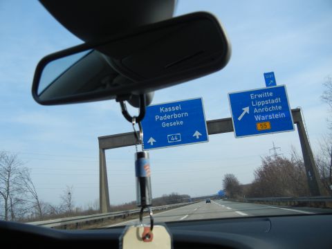 2010 Audi A4 - Highway signs indicate directions to various German cities, viewed from inside a vehicle.