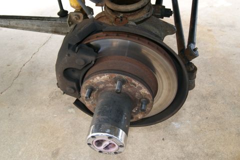 1978 Ford Bronco - This image shows a close-up view of a vehicle's brake system, including the rotor and caliper.
