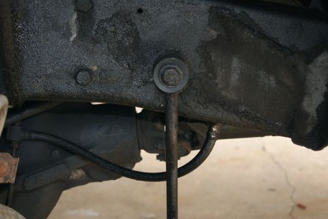 1978 Ford Bronco - Close-up of the undercarriage, showing suspension components and a brake line, with a SuperMotors.net watermark.