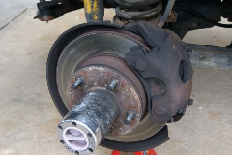 1978 Ford Bronco - Close-up of a vehicle's front wheel brake assembly, showing the rotor and caliper.